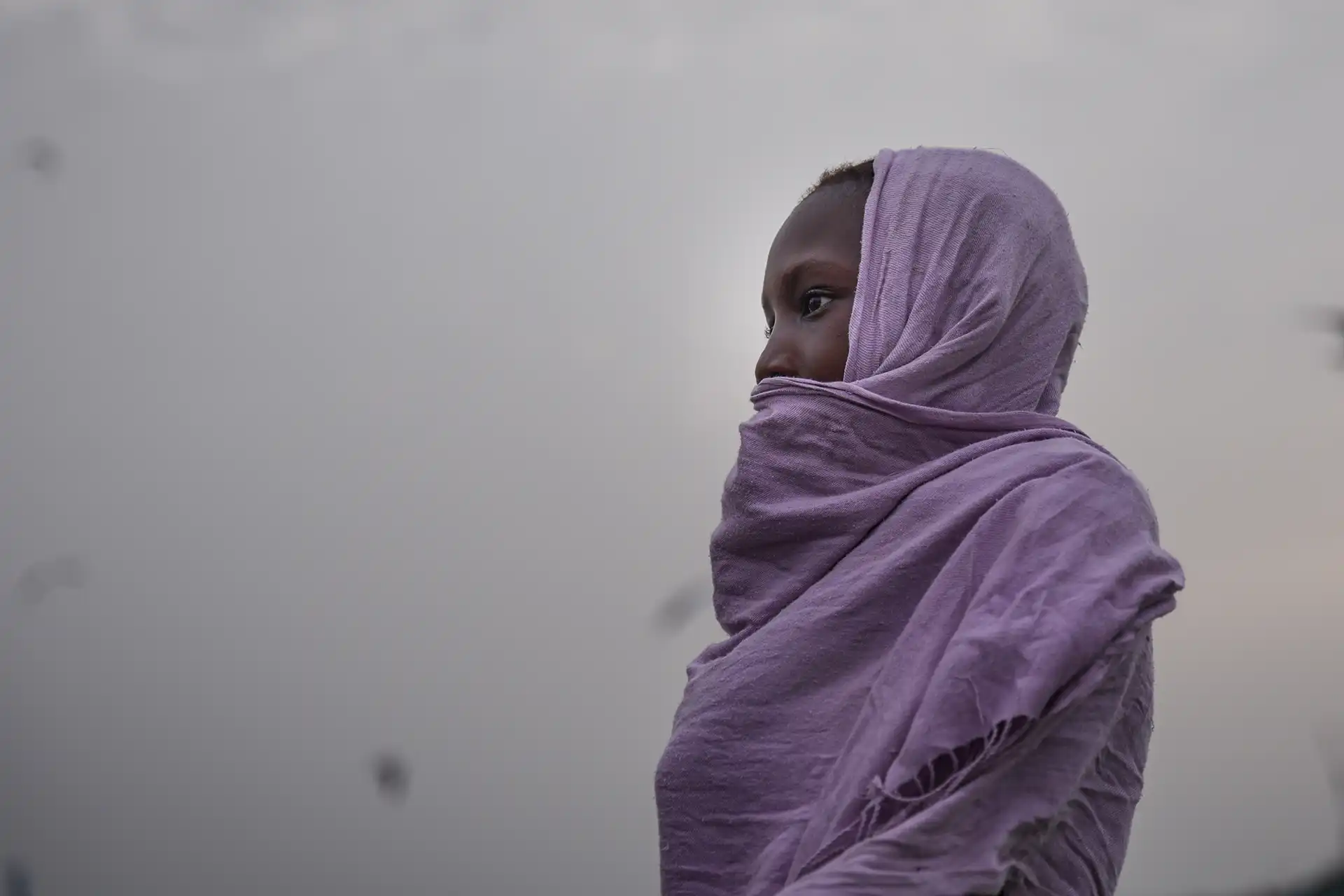 side-view-woman-wearing-scarf-standing-beach-against-sky-sunset